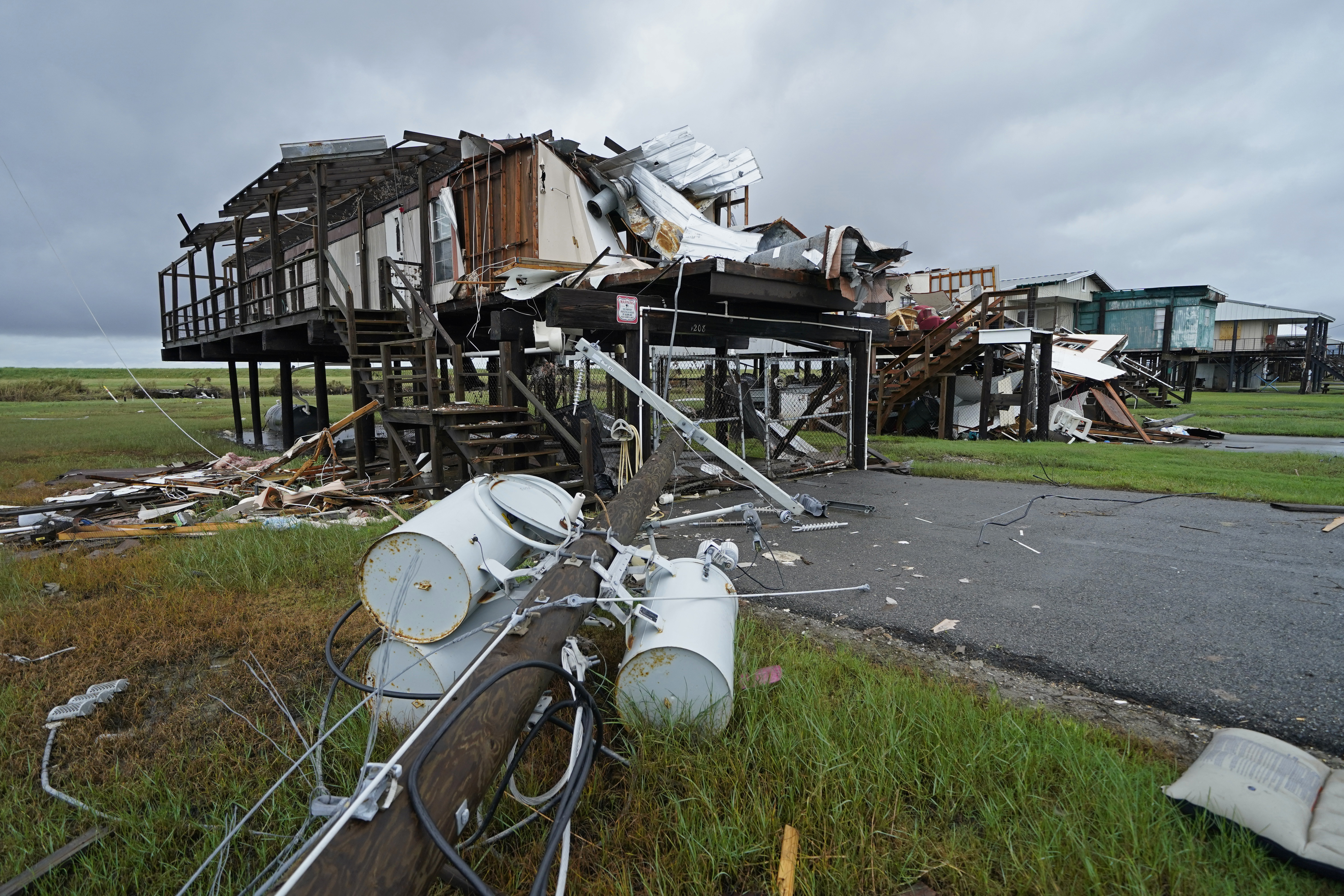 Storm clouds from approaching Tropical Storm Nicholas are seen behind homes destroyed by Hurricane Ida