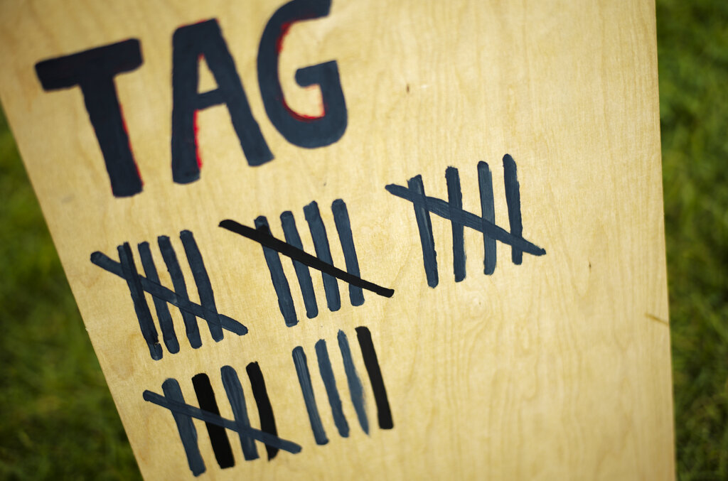 A wooden board marks the duration of hunger strike of climate activists in small camp near the chancellery in Berlin, Wednesday, Sept. 22, 2021. With the hunger strike climate activists hope to pressure candidates for chancellor of Germany into meeting with them for a debate about the climate crisis ahead Sunday's general election. For the first time in Germany's history, climate change is a central issue of an election campaign, overwhelmingly so for the young generation.