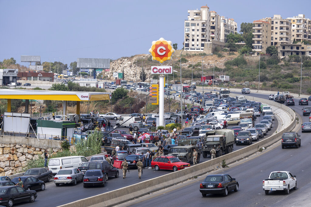 In this Sept. 3, 2021, file photo, cars line up at a petrol station as they try to get gas on the main highway in the coastal town of Jiyeh, south of Beirut, Lebanon. Countries like Lebanon, Syria, Iraq, Lebanon and Yemen are all teetering on the brink of humanitarian catastrophe with an economic implosion that threatens to throw the region into even deeper turmoil.