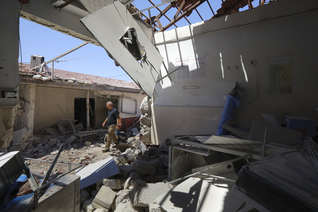 In this June 13, 2021, file photo, a man walks through a heavily damaged hospital in the city of Afrin, Syria. Countries like Lebanon, Syria, Iraq, Lebanon and Yemen are all teetering on the brink of humanitarian catastrophe with an economic implosion that threatens to throw the region into even deeper turmoil.