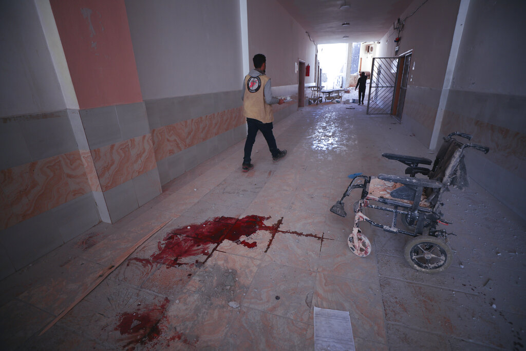 In this March 22, 2021, file photo, blood splatters the floor of a hospital in Atareb, a town in rural western Aleppo, Syria. Artillery shells fired from government areas killed at least five civilians and wounded medical staff when they landed in front of the hospital. Countries like Lebanon, Syria, Iraq, Lebanon and Yemen are all teetering on the brink of humanitarian catastrophe with an economic implosion that threatens to throw the region into even deeper turmoil.