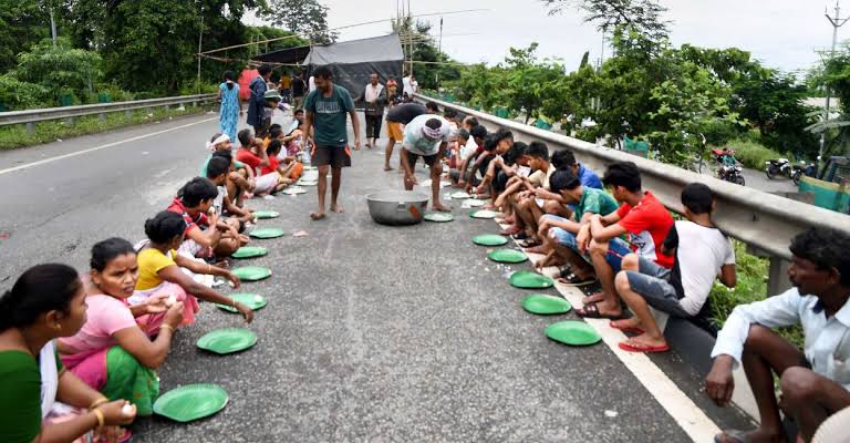 children and pregnant woman in shelter camps in flood ravaged assam