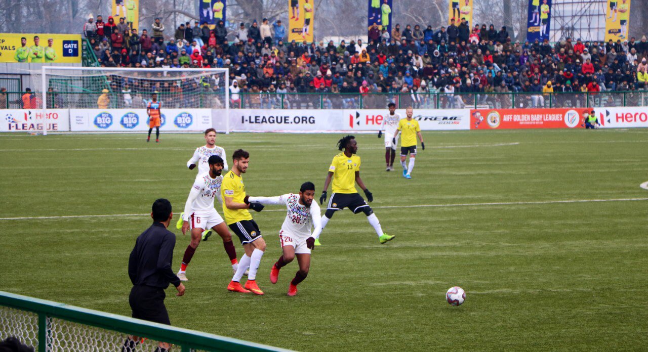 Mohun Bagan and Real Kashmir players fight for the ball.