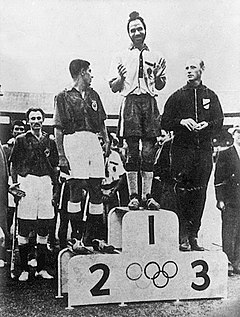 Balbir Singh Senior on top of the podium with the gold medal.