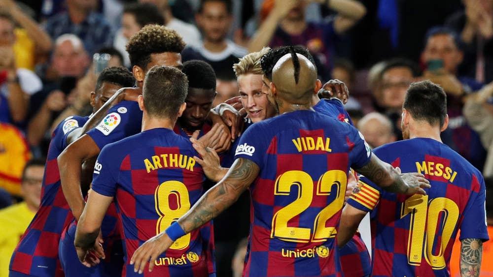 Barcelona players celebrate after handing Sevilla 4-0 defeat at Camp Nou.