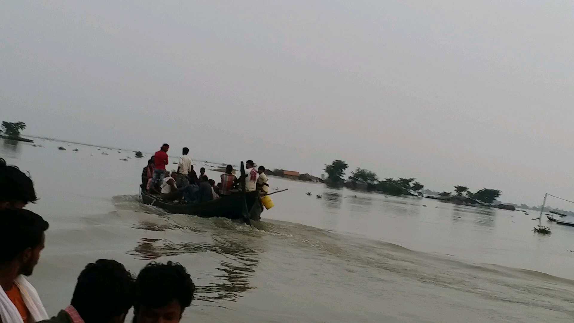 over capacity people ride on private boat in flood affected area in madhepura