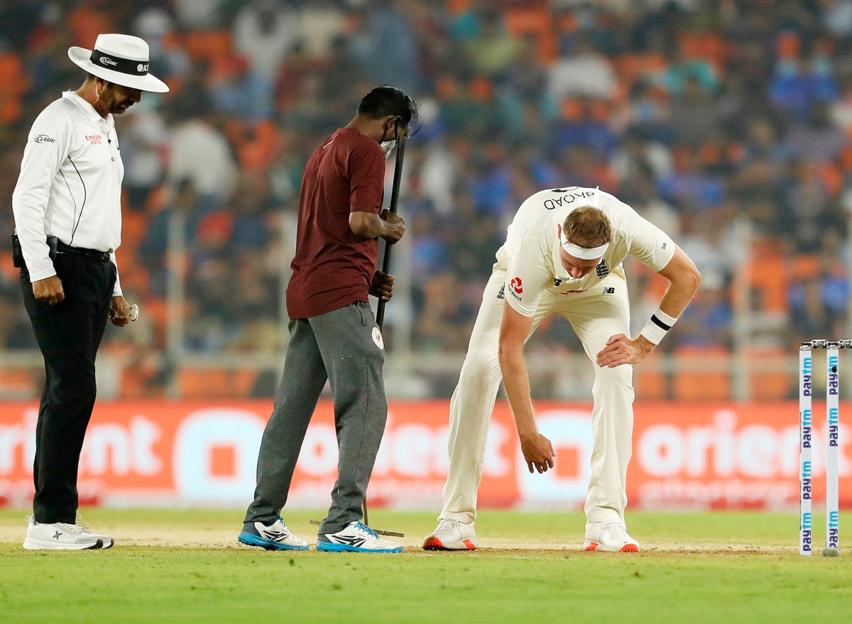 Umpire Anil Chaudhary and England bowler Stuart Broad inspect the Motera pitch.