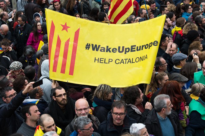 Protesters flaunt a placard during the protest rally in Catalonia.