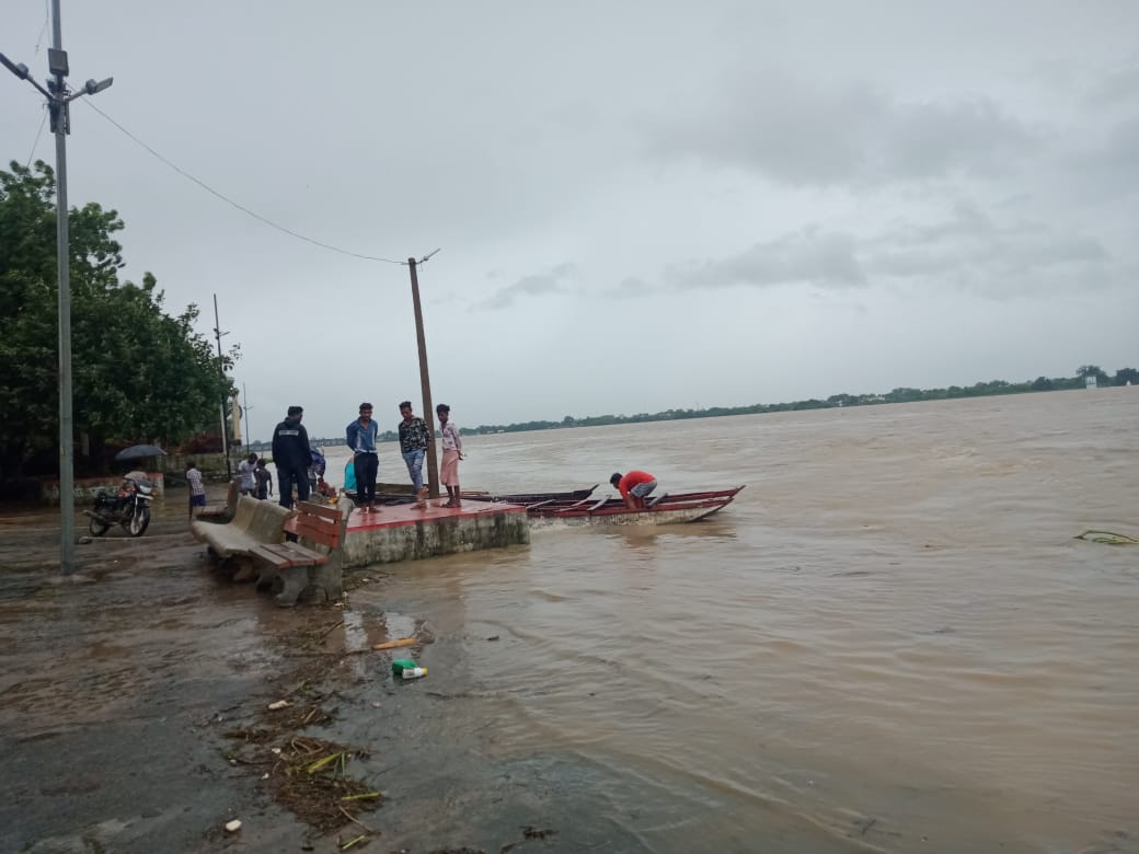 People crossing the river by boat