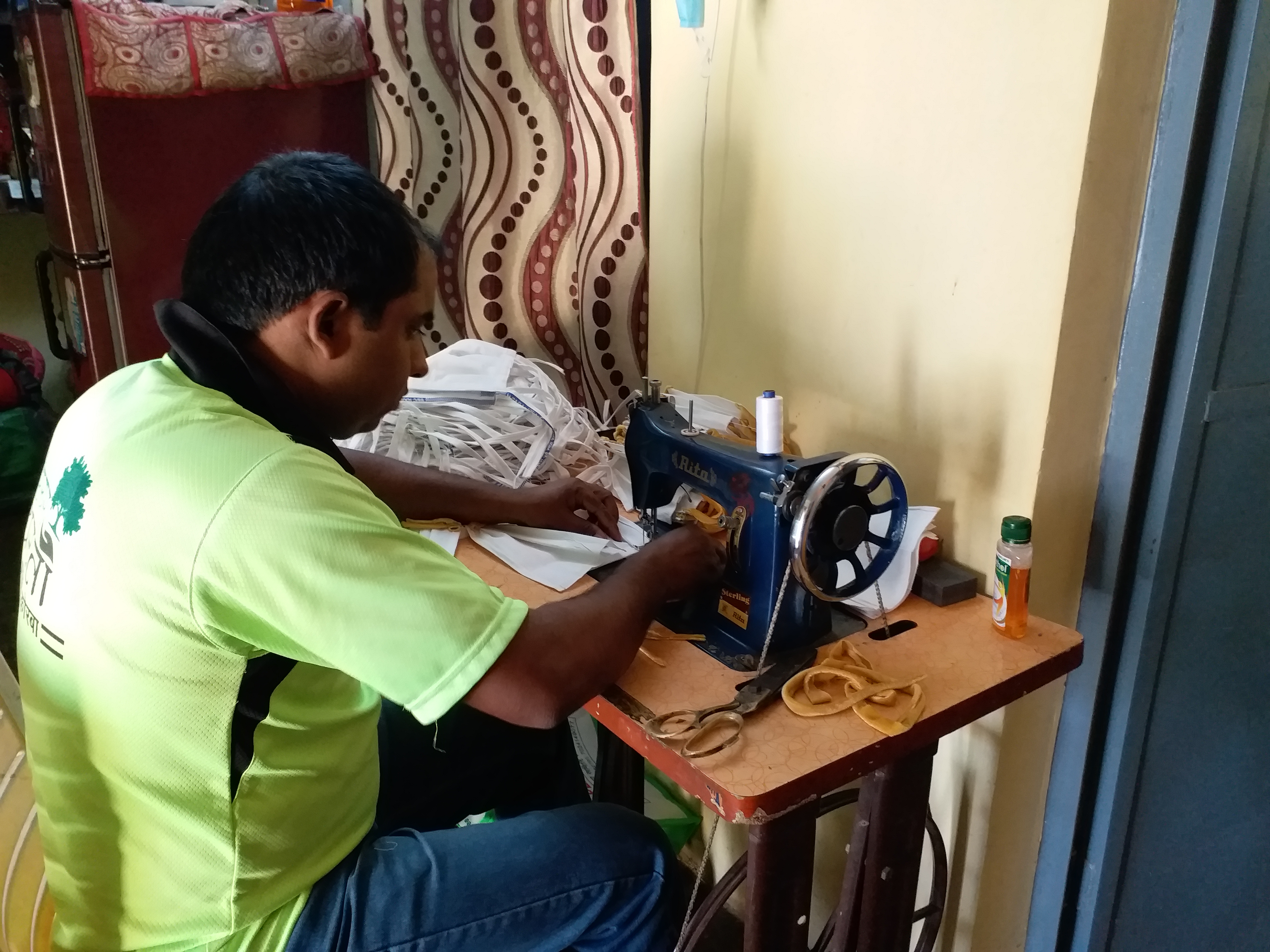 Railway employees prepare masks after duty in korba