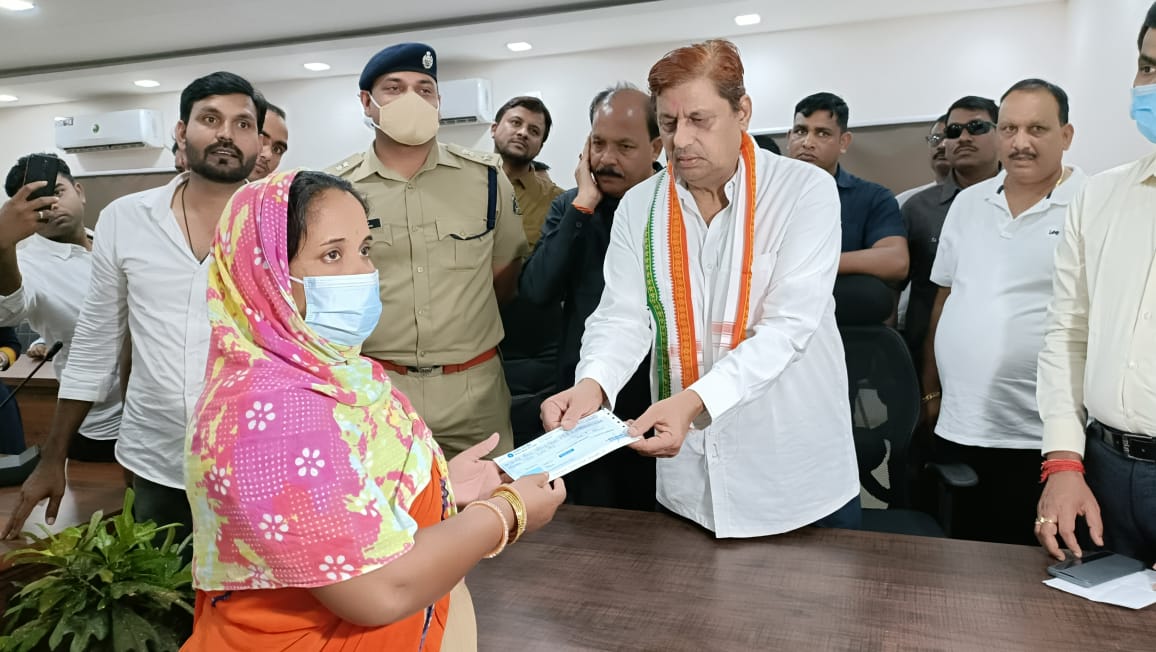 Forest Minister distributing the check