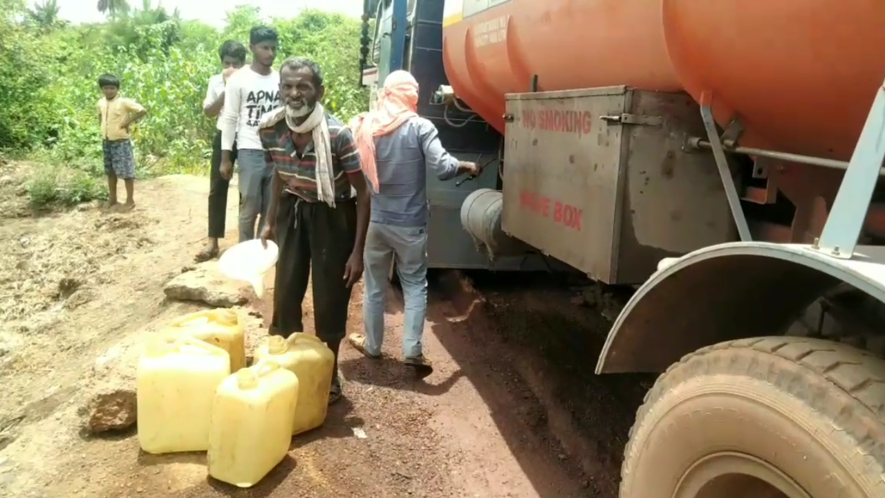 People extracting diesel from tanker