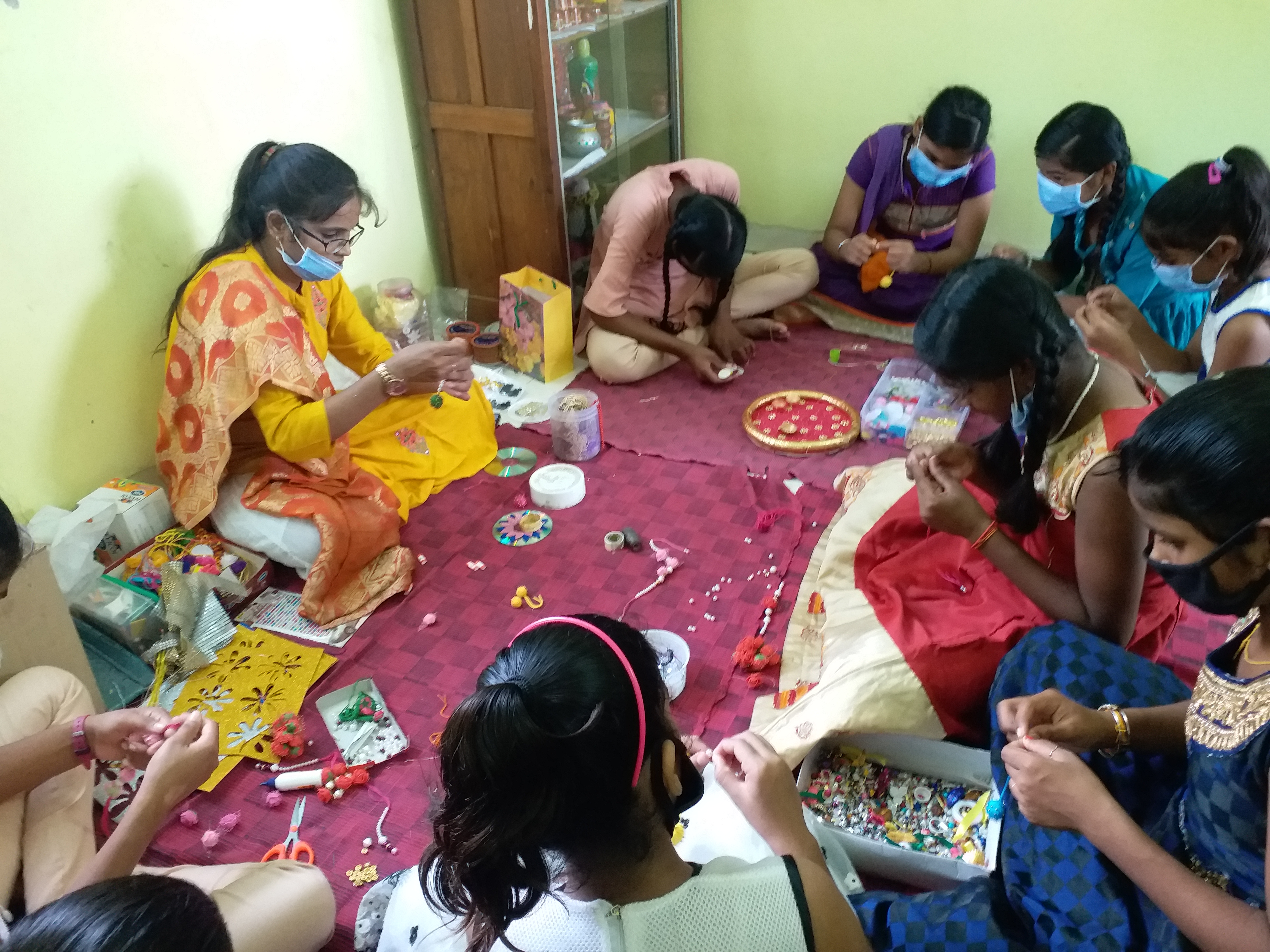 girl child house are making rakhi to earn money