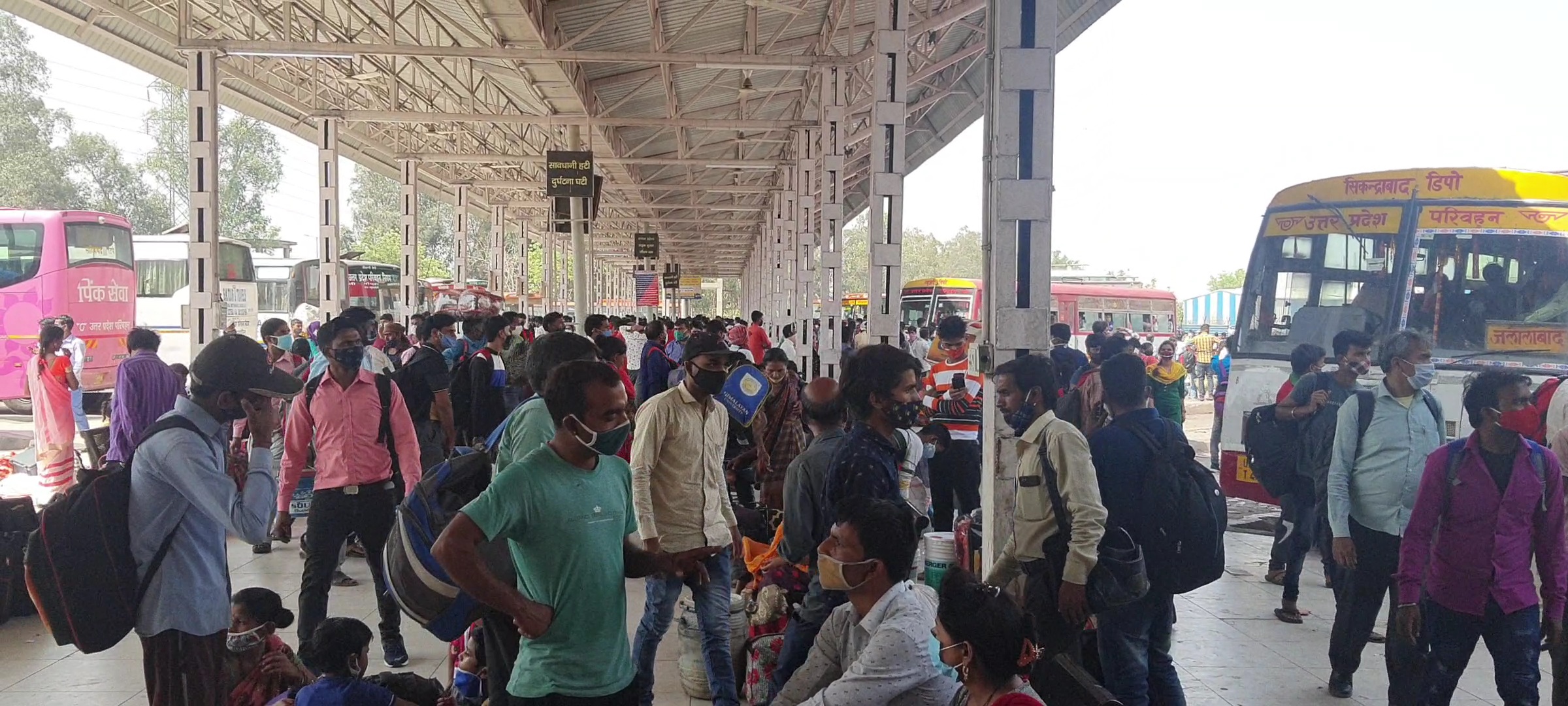 migrant workers at bus stand