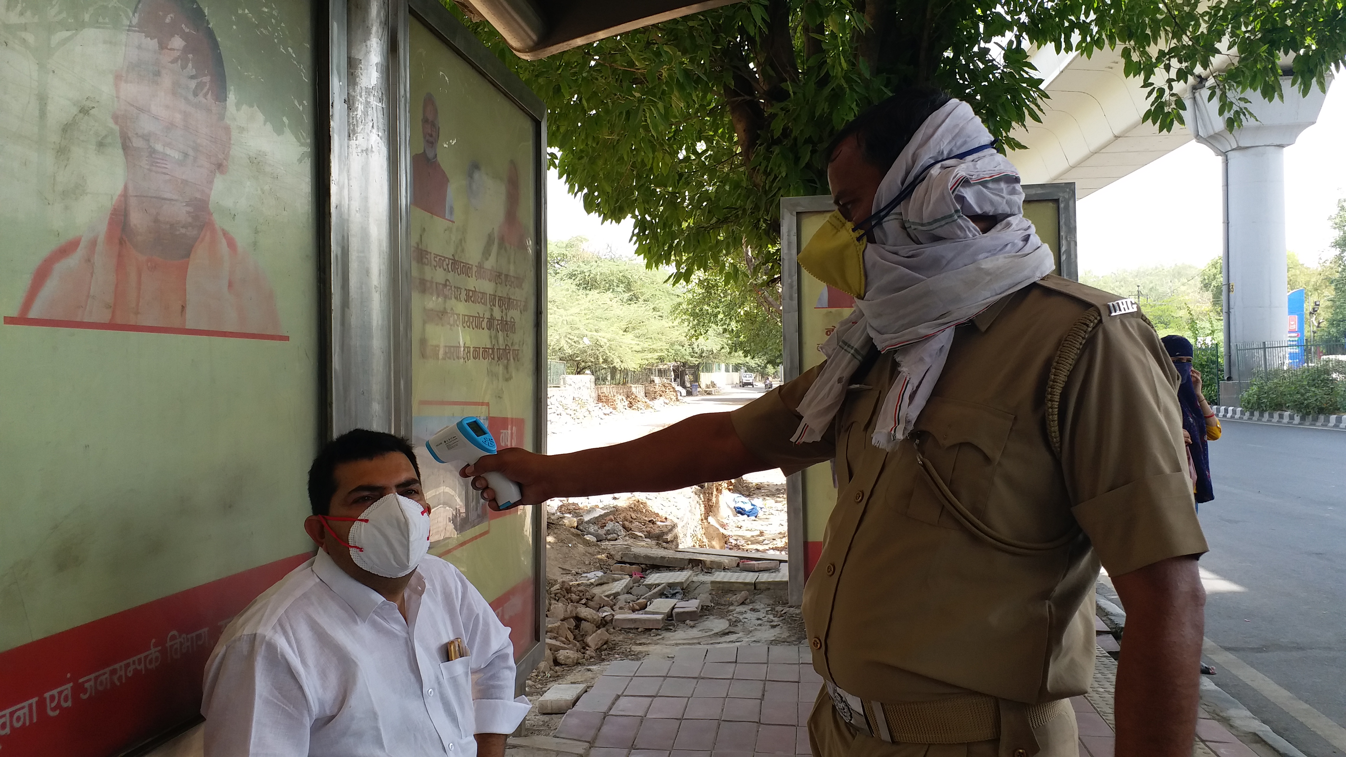 Thermal screening of people being done at bus stop due to corona