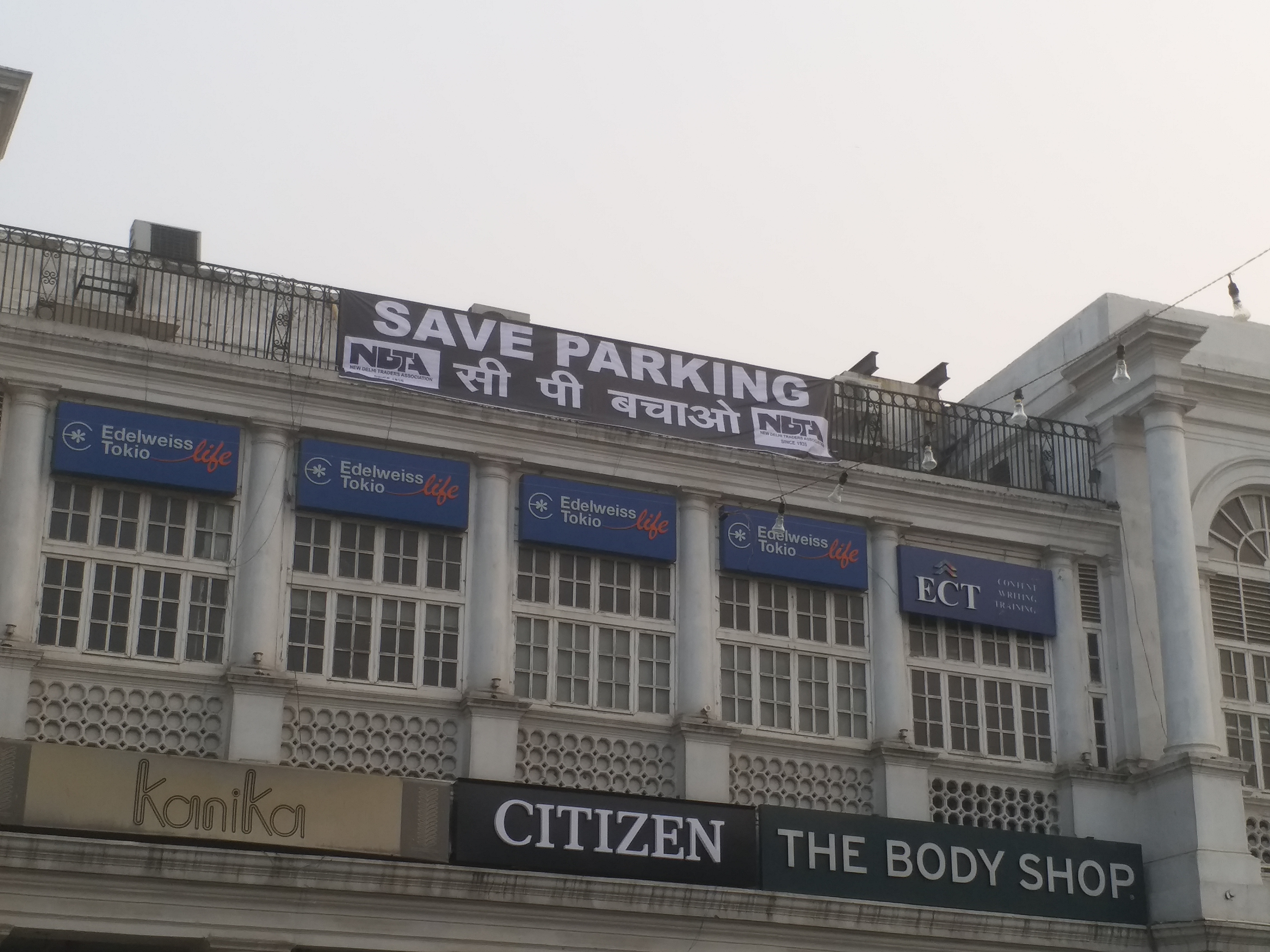 shopkeprs display save parking posters in cp protesting against laser show