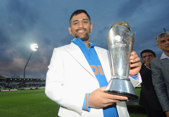 MS Dhoni with the 2013 Champions Trophy bust.