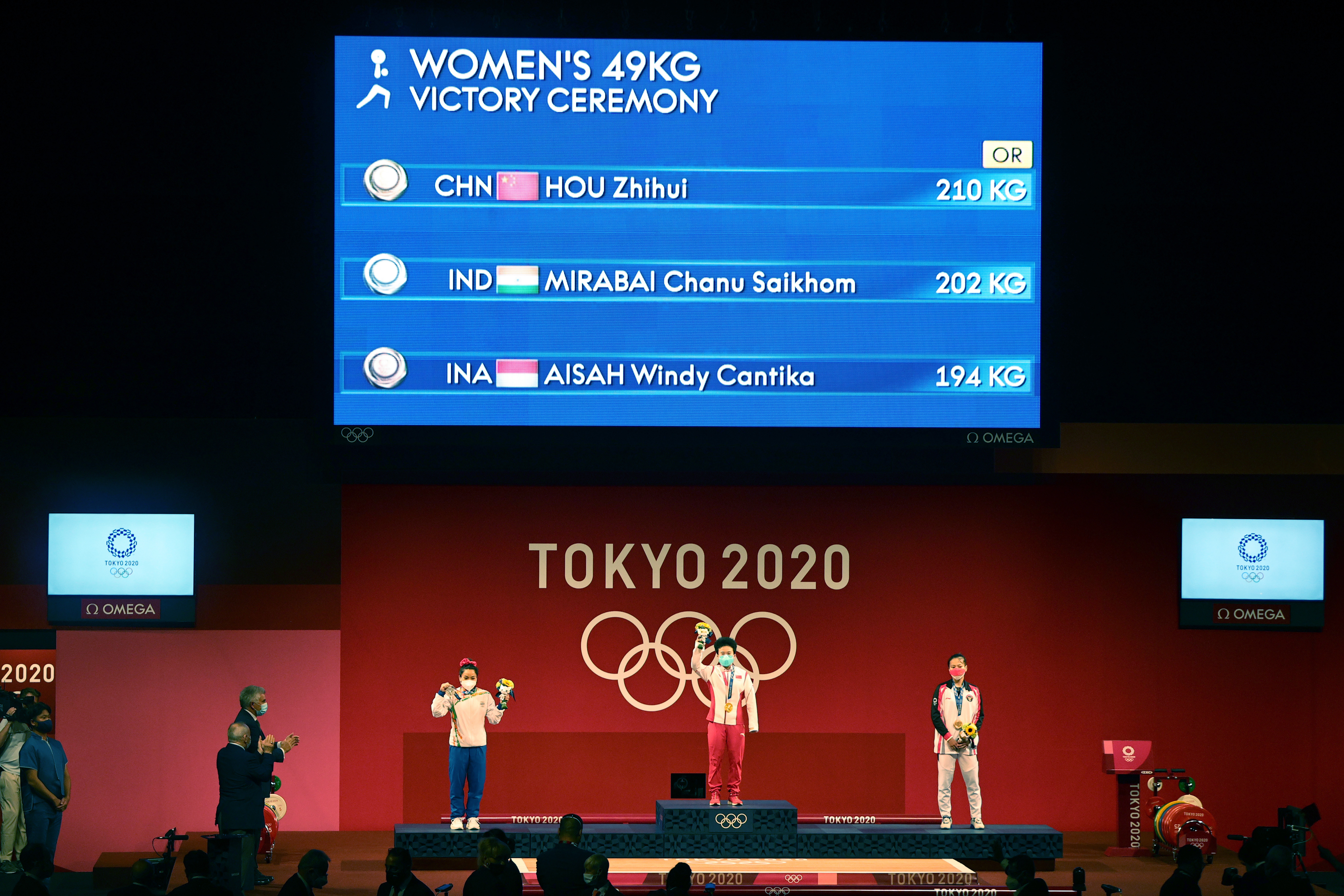 Weightlifter Mirabai Chanu (first from the left) flaunting her silver medal at the Olympic podium.