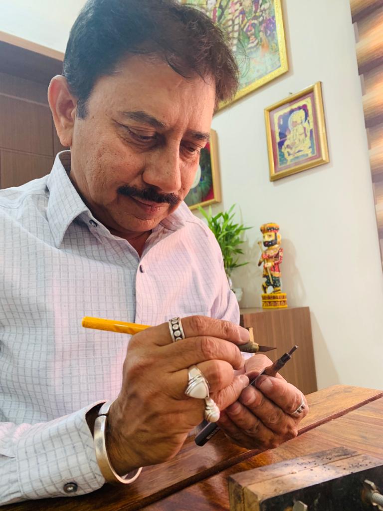 Deepakbhai Bhatt carving a pencil