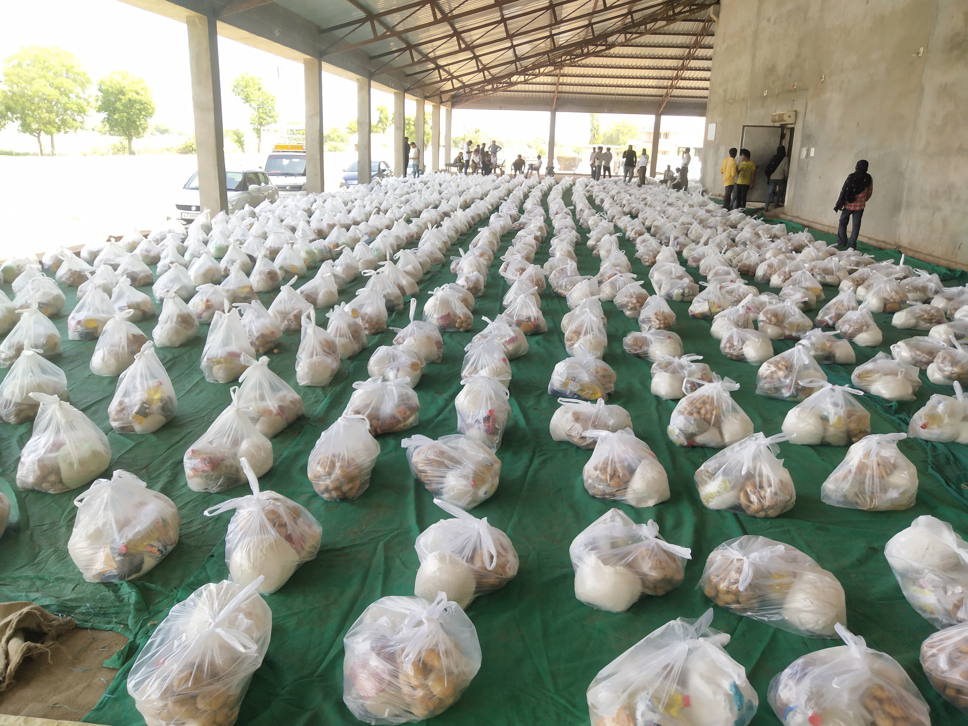 a young man distribute food kit to needful people