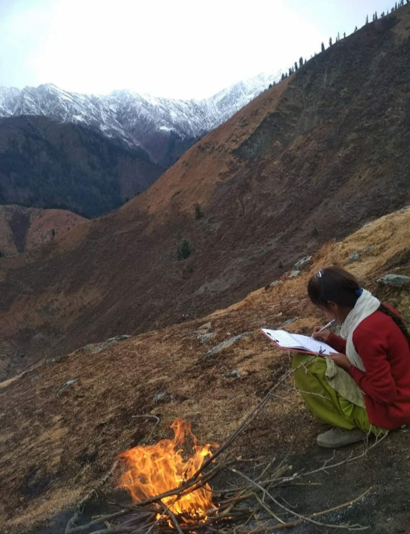 A student lighted firewood to keep herself warm