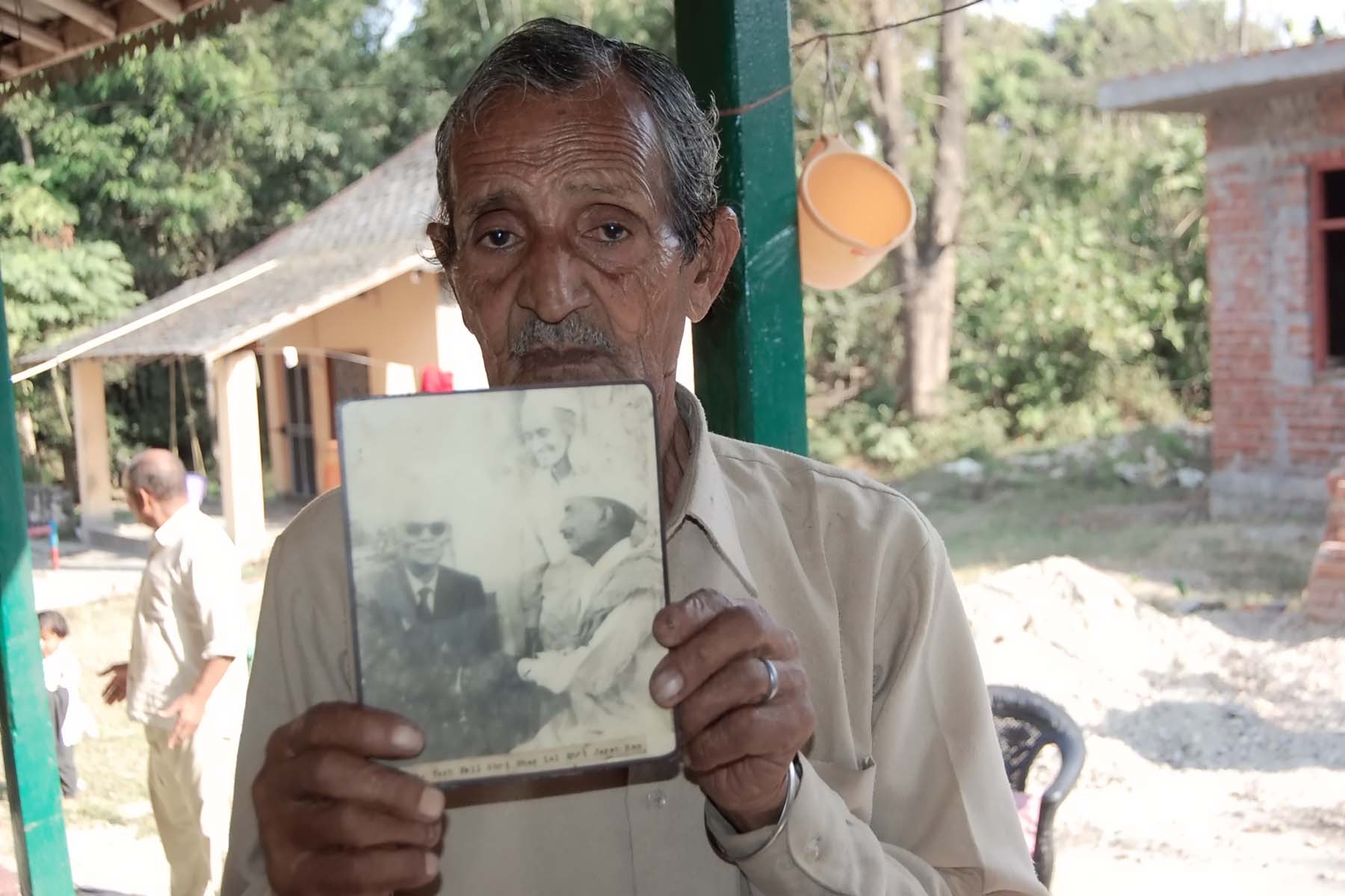 Yashpal's relative showing his photograph