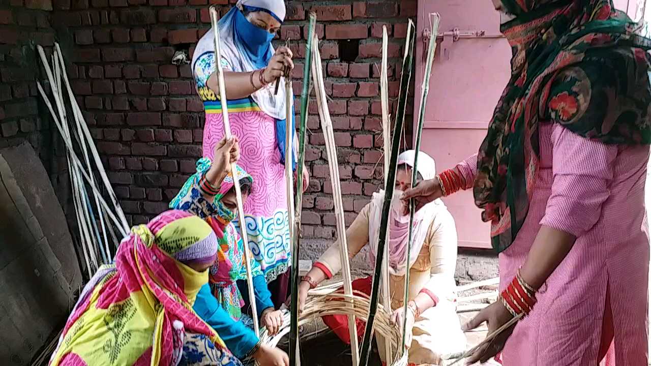 Women make tree guards from bamboo