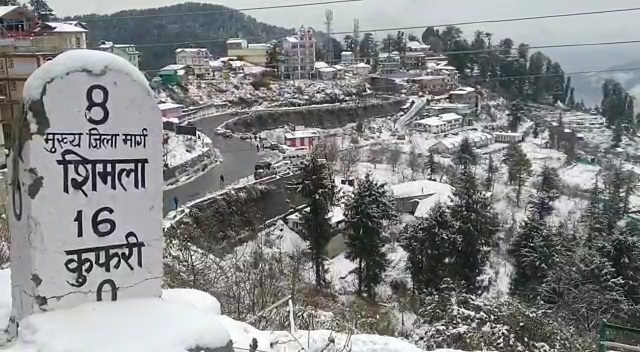 Tourists in kufri during snowfall in himachal pradesh