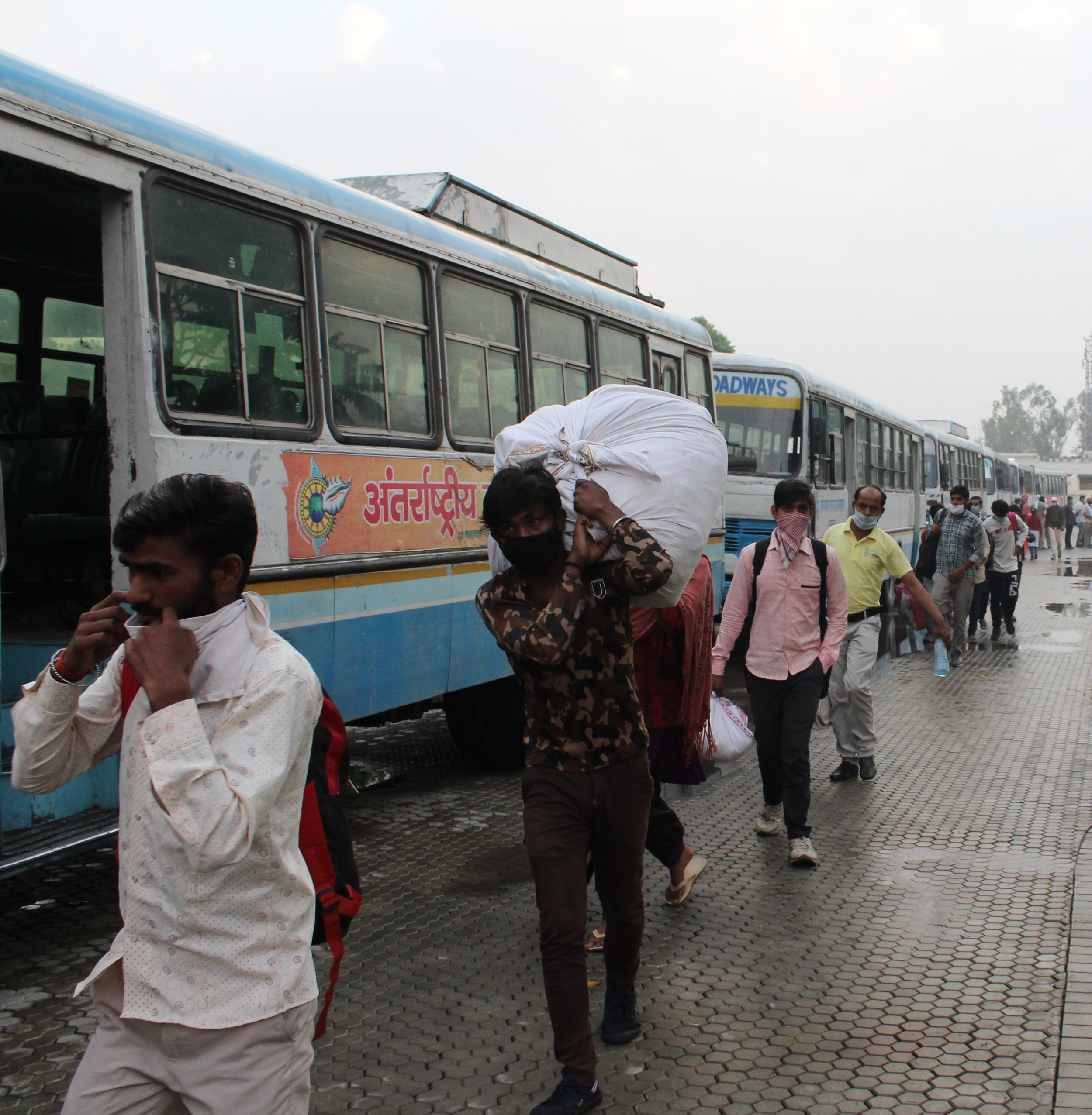 Migrant laborers keeping their belongings on the bus