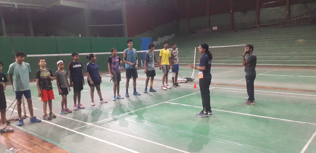 C.H. Deepthi giving instructions to budding badminton players at LB Indoor Stadium's badminton court.