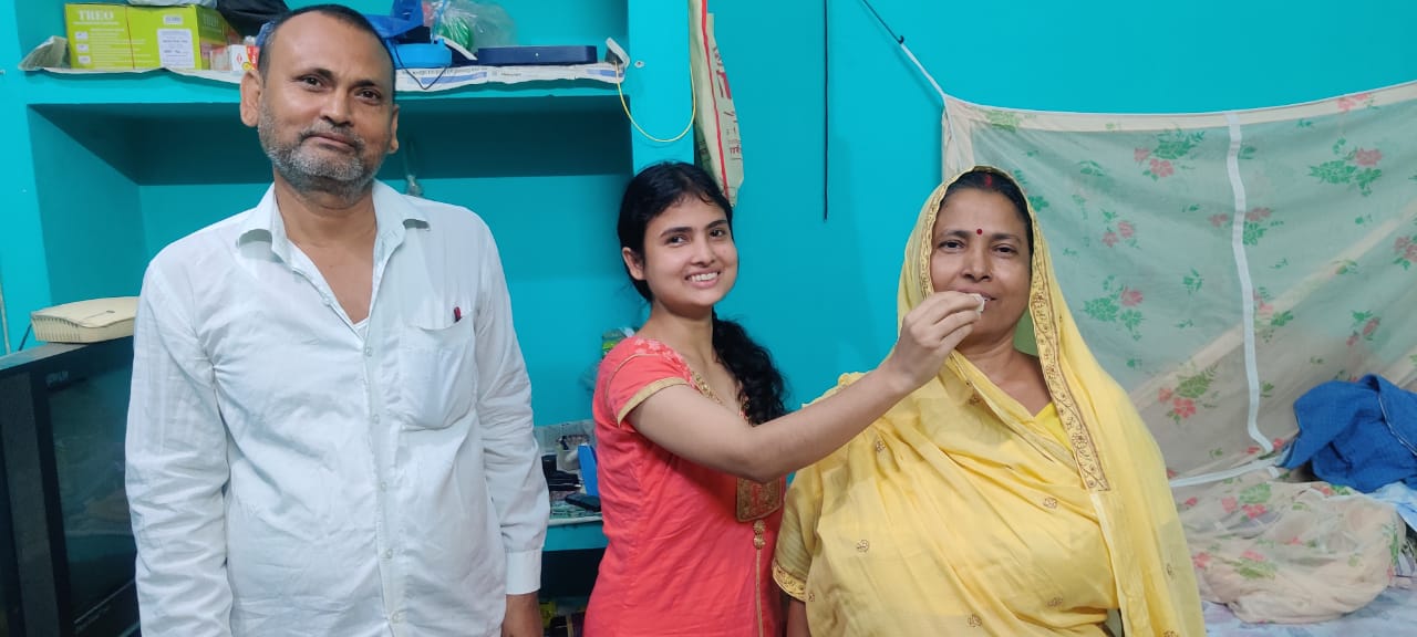 Dr. Apala Mishra eats sweets from mother