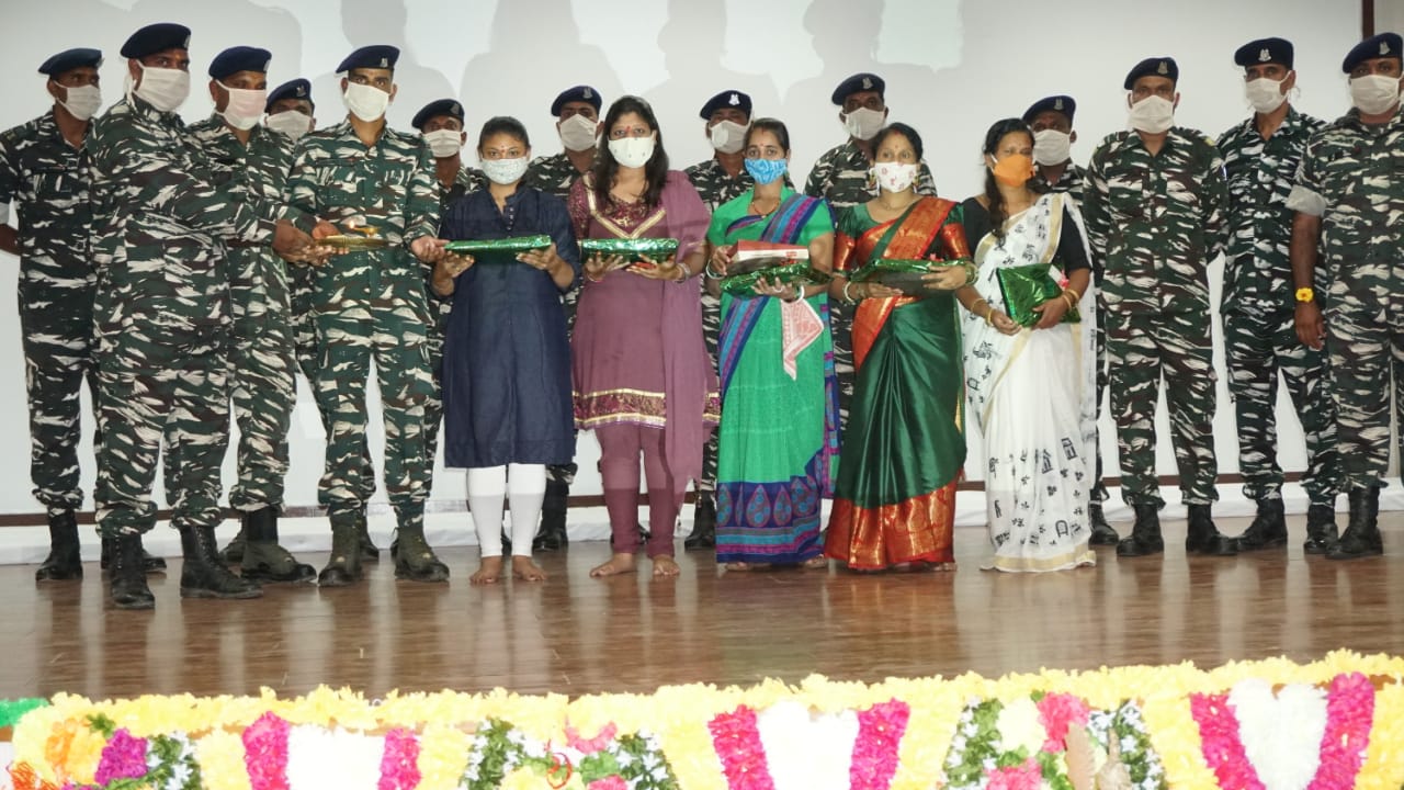 Women standing with soldiers after Rakshabandhan