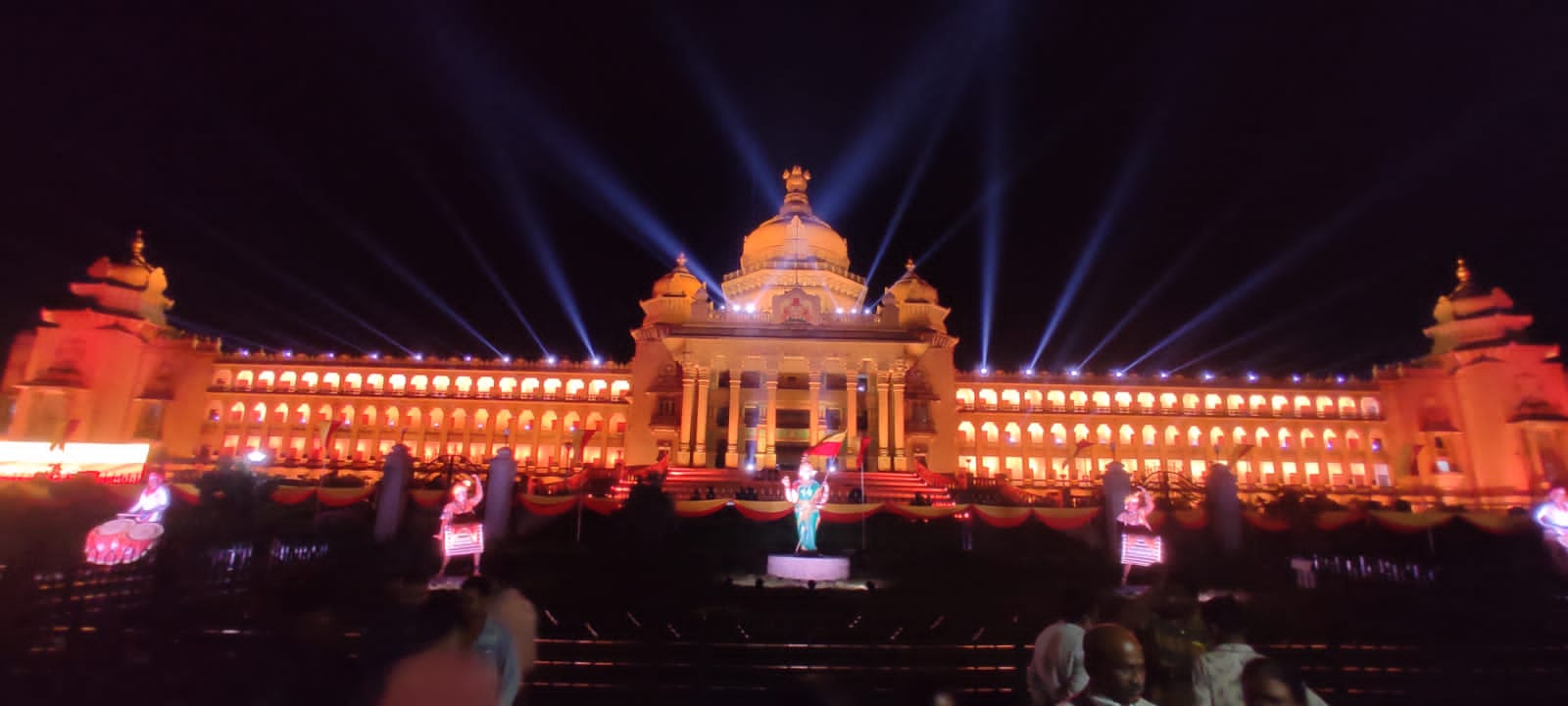 Vidhana soudha adorned with red and yellow electric lighting