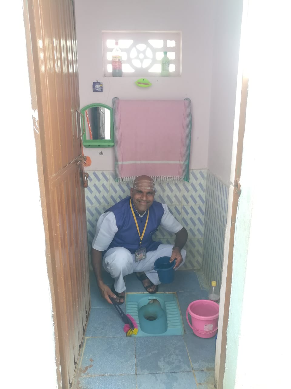 Headmaster cleaning the school toilet