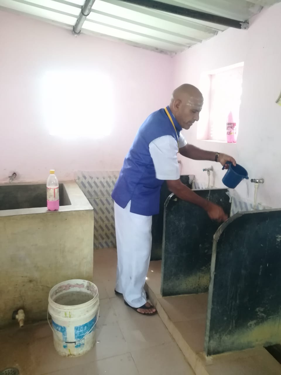 Headmaster cleaning the school toilet