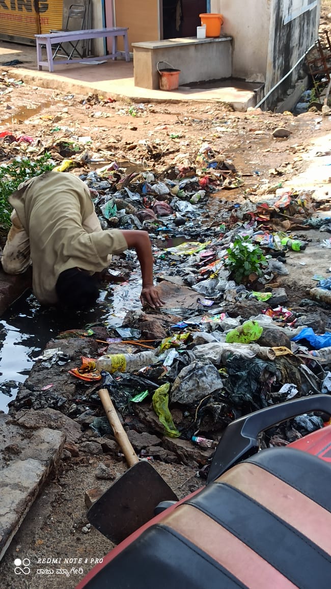 civil worker cleans cleans drainage in bare hands