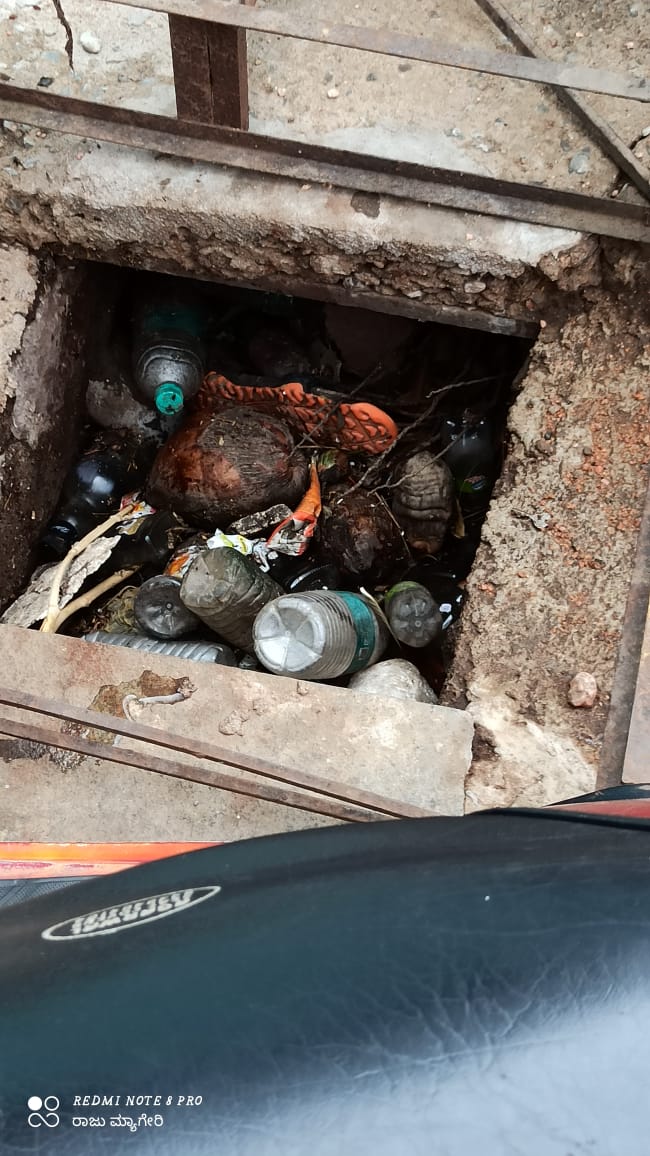 civil worker cleans cleans drainage in bare hands