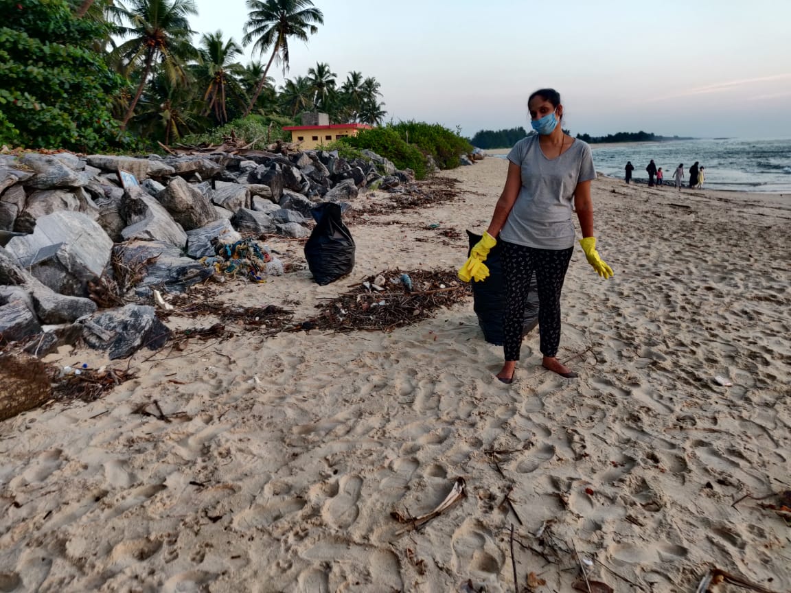 Minusha cleaning the beach