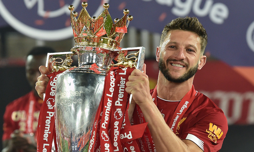 Adam Lallana holding the EPL trophy.