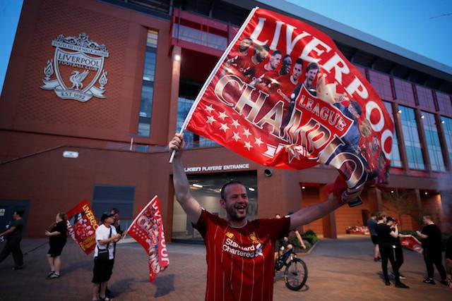 Liverpool fan in front of Anfield