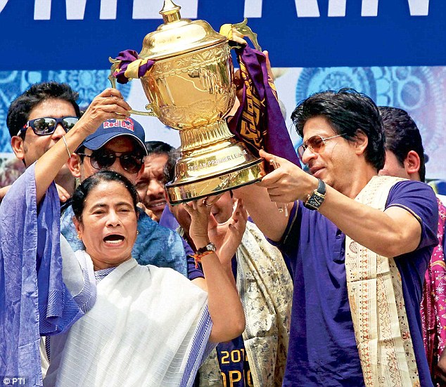 Mamata Banerjee raises the 2012 IPL trophy along with KKR owner and West Bengal ambassador Shah Rukh Khan.