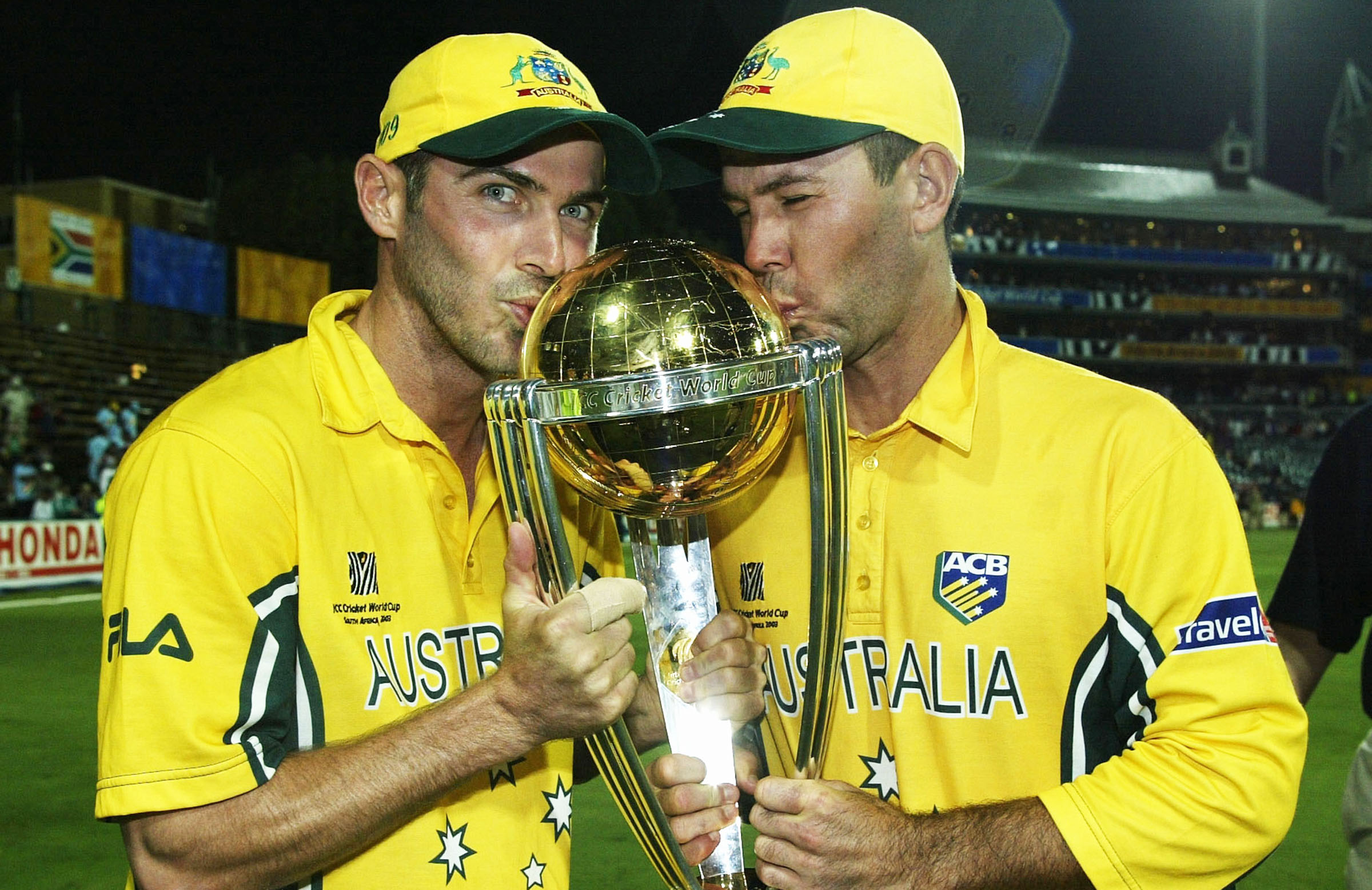 Damien Martin and Ricky Ponting kissing the World Cup trophy.