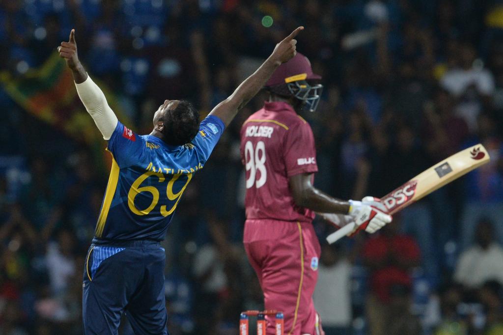 Mathews celebrates after dismissing Jason Holder.