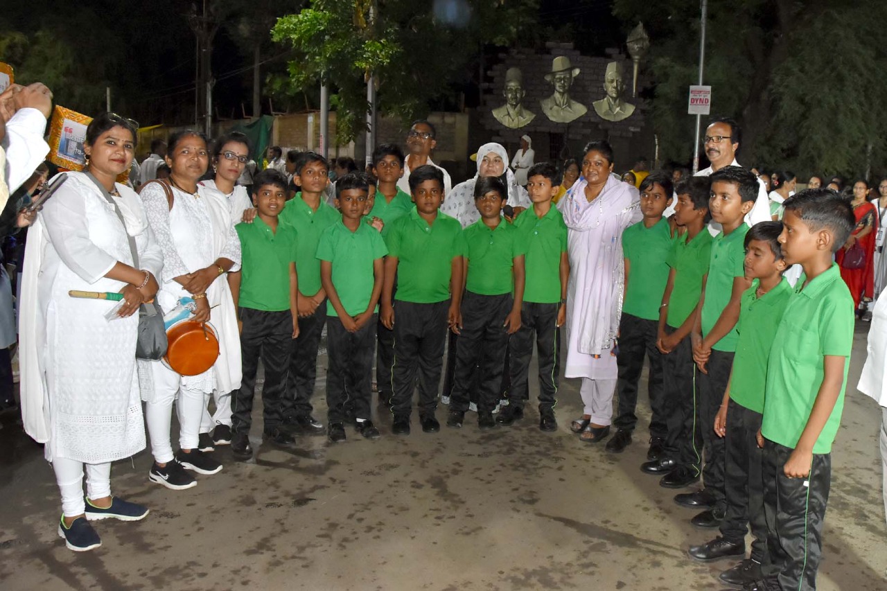 Lady administrators with students performing street plays