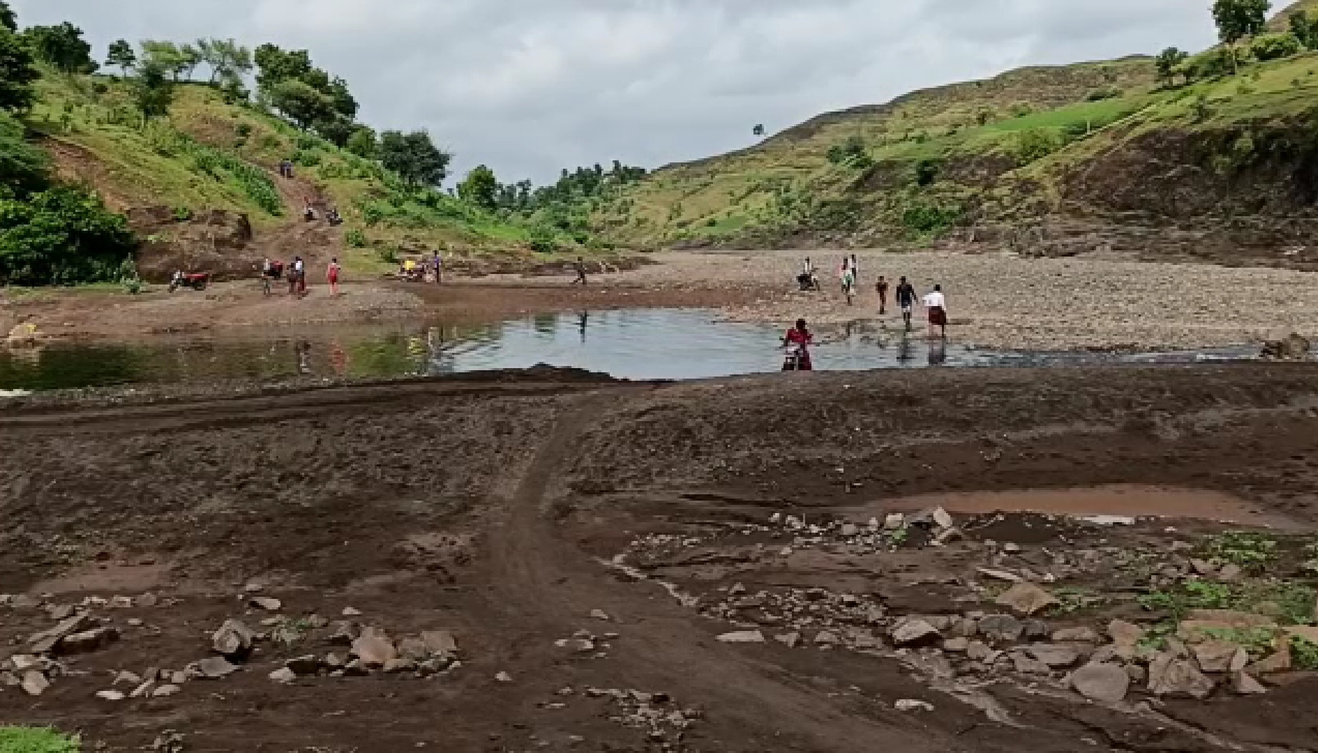 Villagers crossing the river