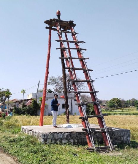 devotees hangs on a 30 feet high pillar in ujjain