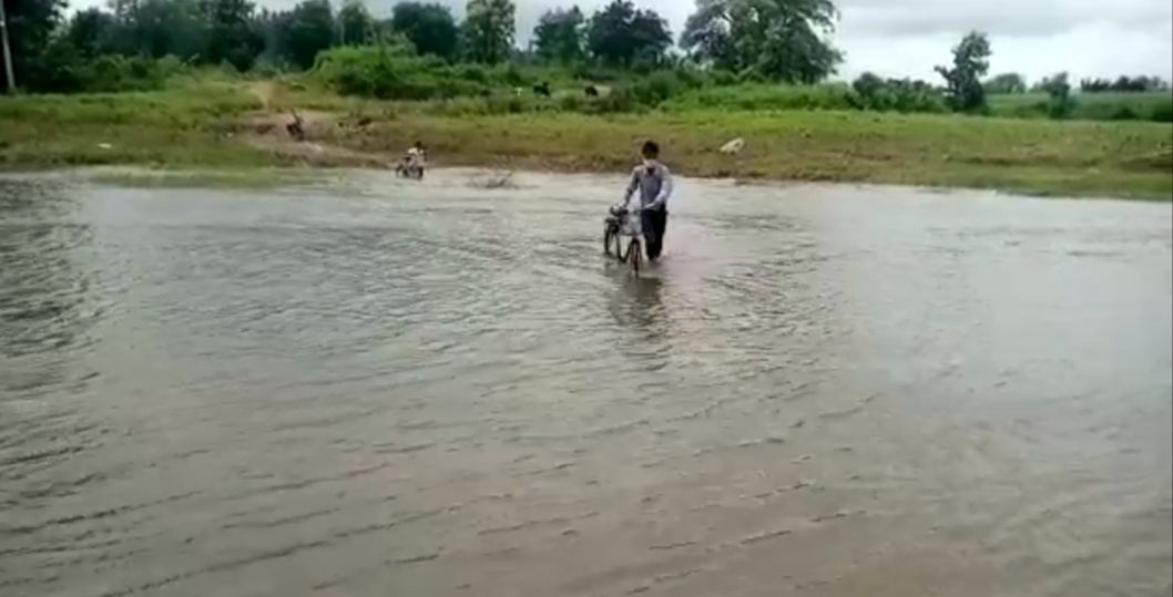 Villagers crossing the river