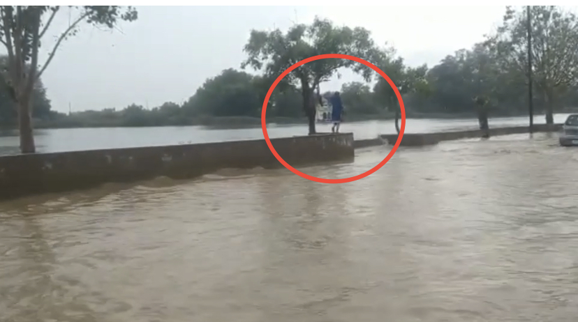 People passing through the wall built on side of road