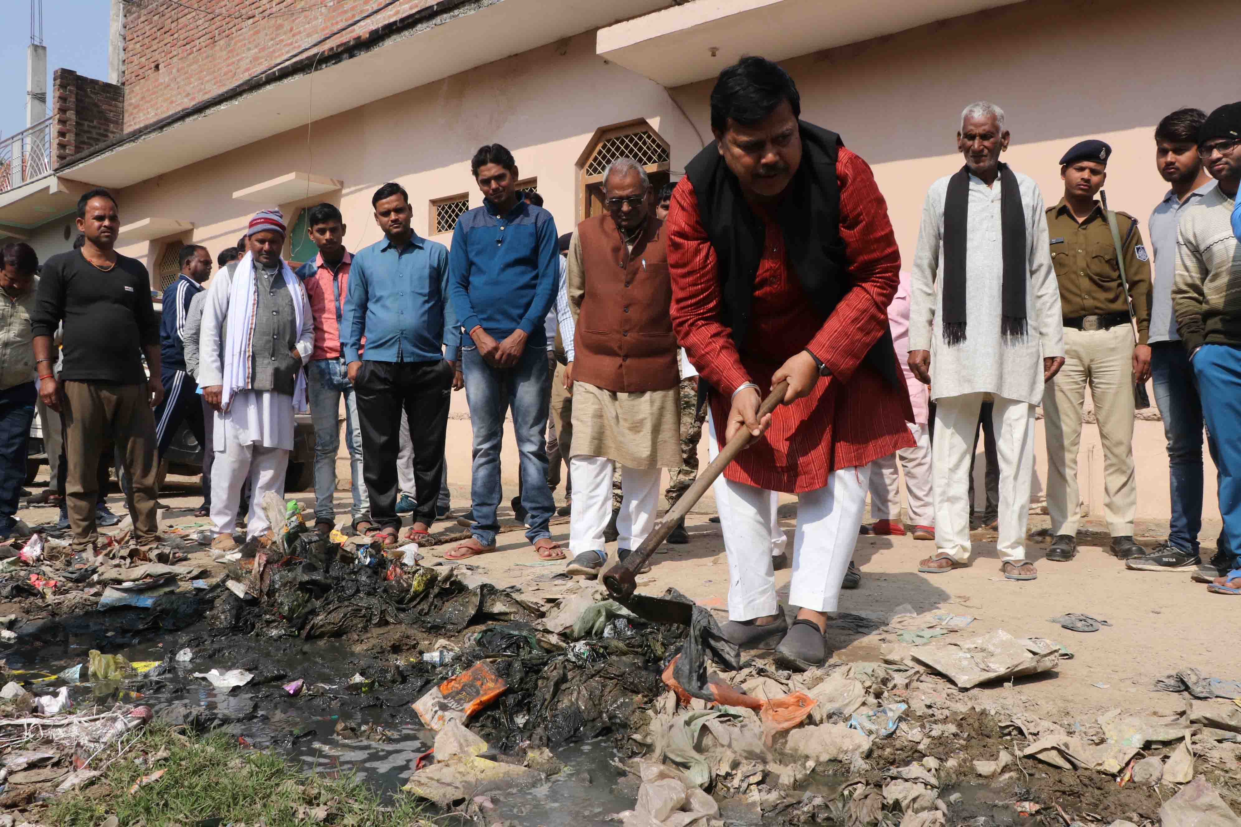 Minister cleans the drain