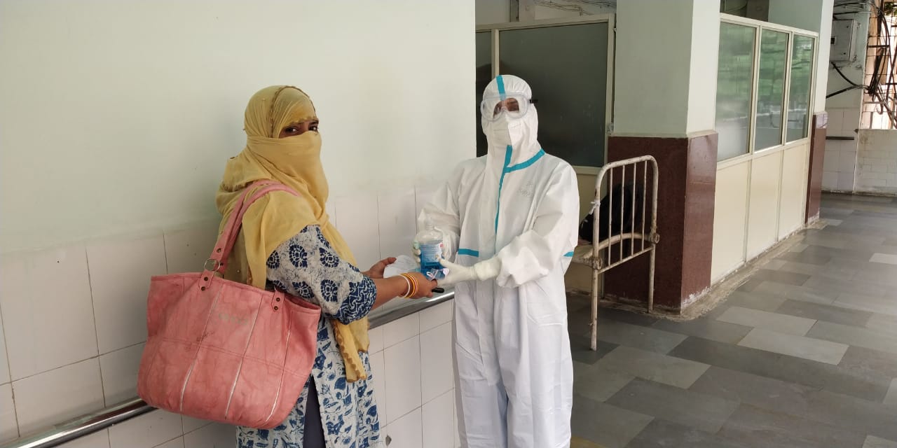 A doctor giving sanitation to a pregnant woman